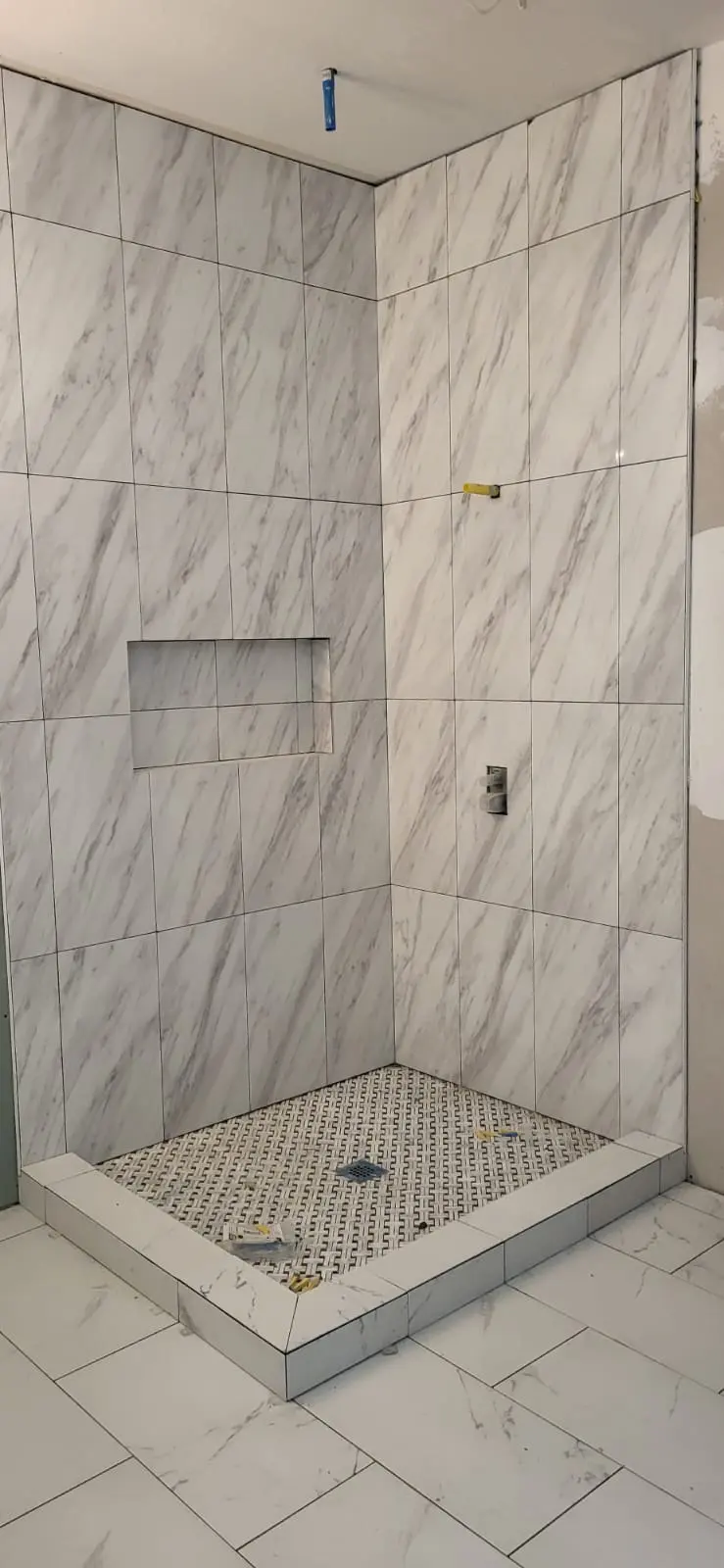 Tile installation in progress on a walk-in shower in Hattiesburg, MS