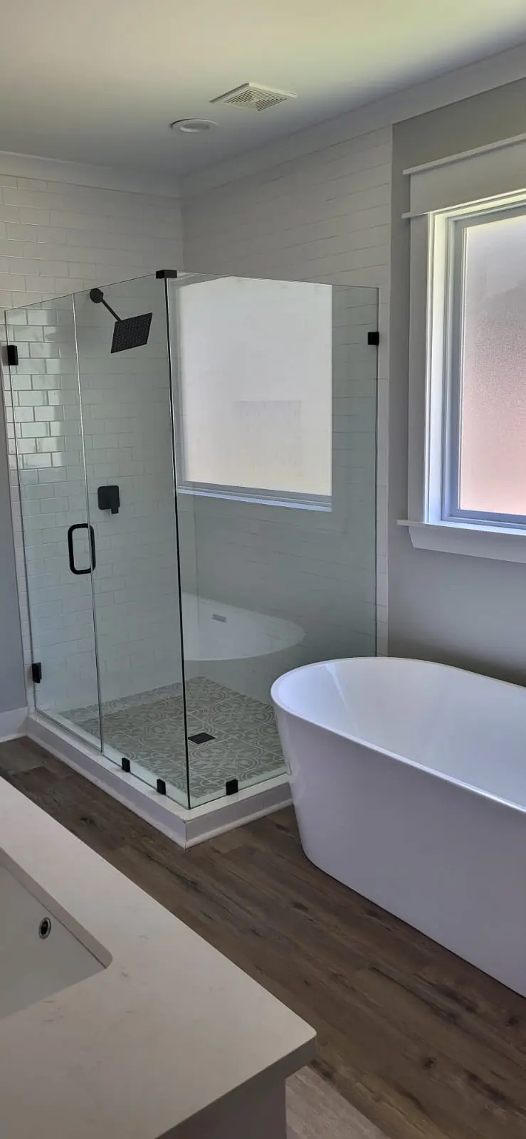 Glass-enclosed shower and freestanding tub, bathroom remodel in Hattiesburg, MS