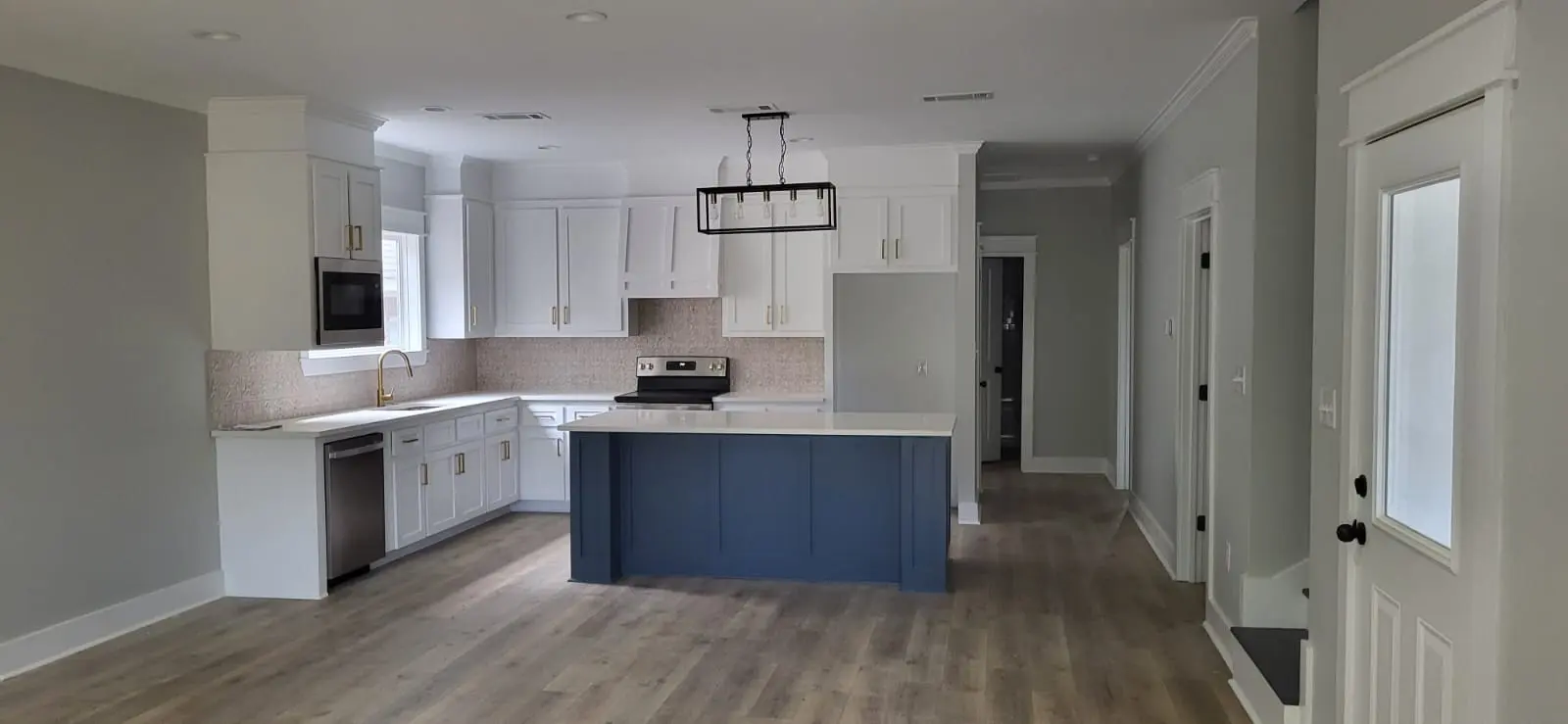 Kitchen remodel with navy blue island and white cabinets in Hattiesburg, MS