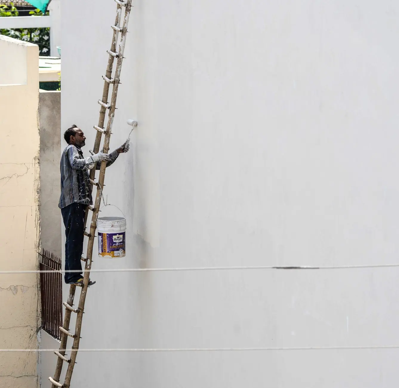 Exterior house painting from a ladder, painting contractor in Hattiesburg, MS